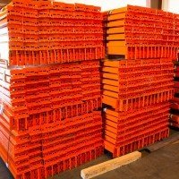 Pallet rack beams stacked neatly in a pile